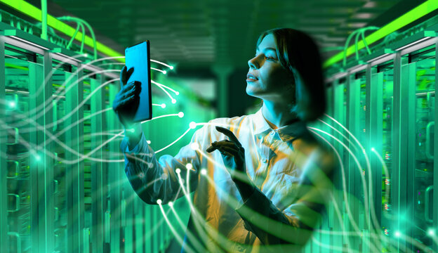 Woman with tablet in data center surrounded by digital network connections, managing servers and cloud computing technology. Information Technology.