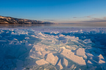 Baikal Lake in winter. Beautiful landscape with mountains reflected in ice of frozen Small Sea