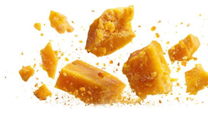 Golden honeycomb pieces scattered and falling isolated on transparent background