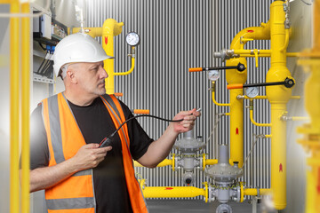 Engineer uses gas analyzer to check pressure pipelines and detect possible leaks. Industrial safety...