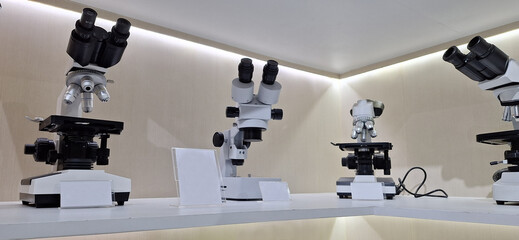 Modern microscope on a white table 