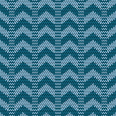 Seamless knitted vector pattern with a classic chevron or zigzag design. This abstract textile background features repeating light and dark blue waves, perfect for fabrics, wallpapers, and cozy digita