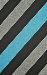 Fototapeta premium Diagonal stripes black, gray, and a light blue swatch