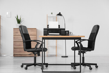 Interior of modern office with printer on table