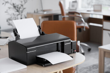 Modern printer with paper sheets on table in office, closeup