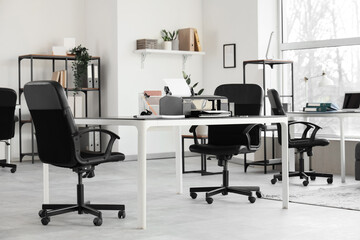 Modern printer on table in office interior
