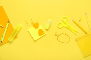 Set of school stationery on yellow background