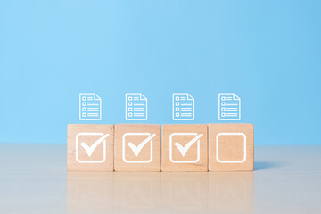 Checklist, Task list, Survey and assessment. Confirmation or Double check. Quality Control. Goals achievement and business success. Check mark and jobs list icon on wooden blocks