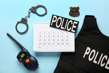 Calendar with policeman's items on blue background