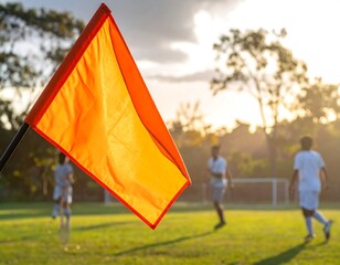 Soccer flag on a field at sunset