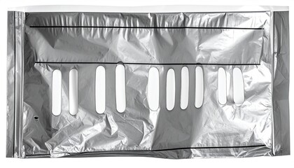 Rectangular, silver-colored bag with a series of oval cutouts; the item is crumpled