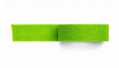 Bright green rectangular foam tape roll and a short unrolled strip, white backdrop