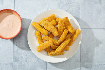 A top down view of a plate of gluten-free fish sticks.