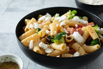 A view of a bowl of gluten-free rigatoni pasta salad.