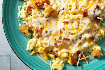 A top down view of a breakfast bowl, topped with dairy-free cheese.