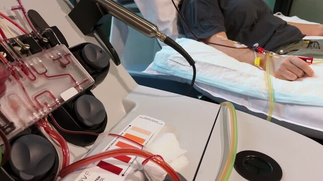Blood Returning to Patient from Apheresis Machine. Clinical healthcare footage highlighting transfusion process, cancer treatment and modern medical technology in action.