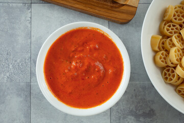 A top down view of a bowl of pink pasta sauce.