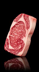 A vibrant, marbled ribeye steak cut, showcasing its rich texture and fat content, reflected on a glossy black surface.