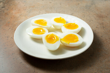 A view of halves of 7 minute hard boiled eggs, on a plate.