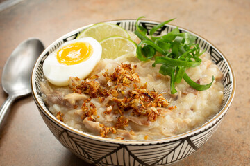 A view of a bowl of arroz caldo.