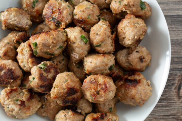A top down view of a bowl of meatballs.