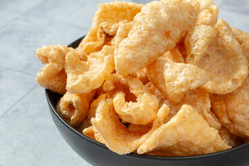 A closeup view of a bowl of chicharrones.