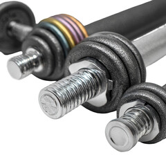 Close-up of various dumbbell weights.  Different colored weight plates and metal barbell sections are visible