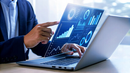 Professional businessman analyzing dynamic financial data charts on futuristic holographic laptop screen for business growth