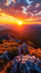 Obraz premium Glowing Sunset over Mountain Range with Rocky Terrain and Dramatic Sky