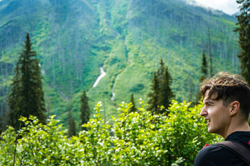 A hiker enjoys a sunny day in the mountains