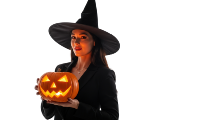 Young woman in a witch costume holding a glowing jack-o'-lantern isolated on a transparent background