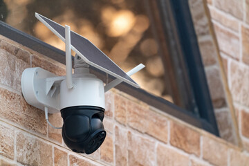 Solar powered wireless security camera on country house wall