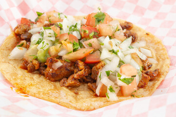 A closeup view of an al pastor taco.