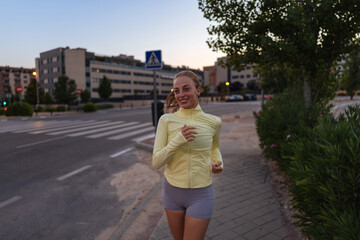 Obraz premium Young Woman Jogging on Urban Pathway at Dusk