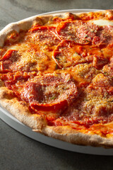 A closeup view of a spicy salami pizza.