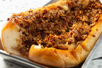 A closeup view of a spicy chicken Philly sandwich.