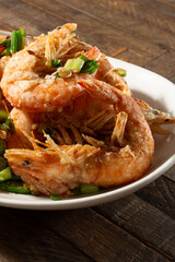 A closeup view of a plate of salt and pepper shrimp.