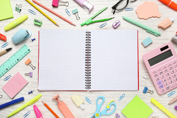 Blank open notebook and different school supplies on white wooden background, closeup