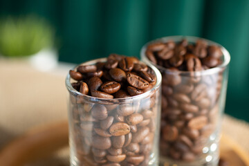 A closeup view of some tall shot glasses full of coffee beans.