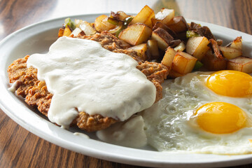 A view of a chicken fried steak breakfast plate.
