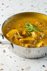 A view of a bowl of basil coconut curry chicken.