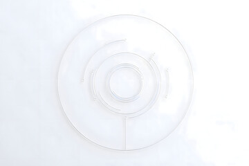 Overhead shot of a transparent plastic turntable on a white background with concentric circles