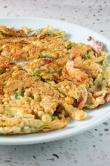 A view of a plate of seafood scallion pancake.