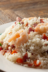 A view of a plate of yang chow fried rice.