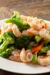 A view of a plate of shrimp broccoli.