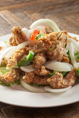 A view of a plate of salt and pepper pork chops.