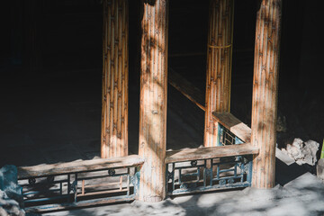 The weathered, gray stone gate features intricate geometric patterns and a repetitive design,...