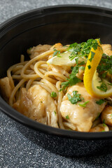 A closeup view of a bowl of chicken piccata.
