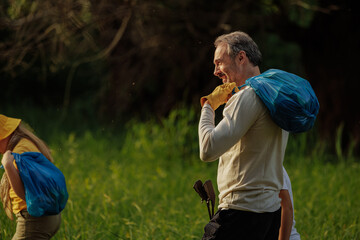 Volunteers collecting garbage in a forest during plogging activity