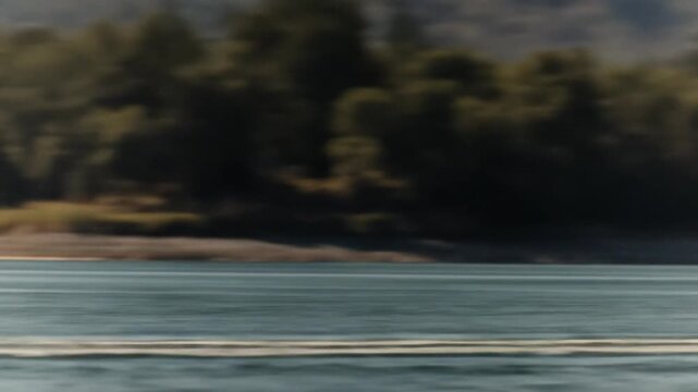 Seaplane taking off on water surface with sky and mountains background